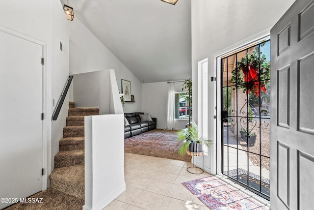 1441 N Calle De Durazo, Tucson, AZ 85715 - foyer with light colored carpet, stairway, light tile patterned floors, and high vaulted ceiling