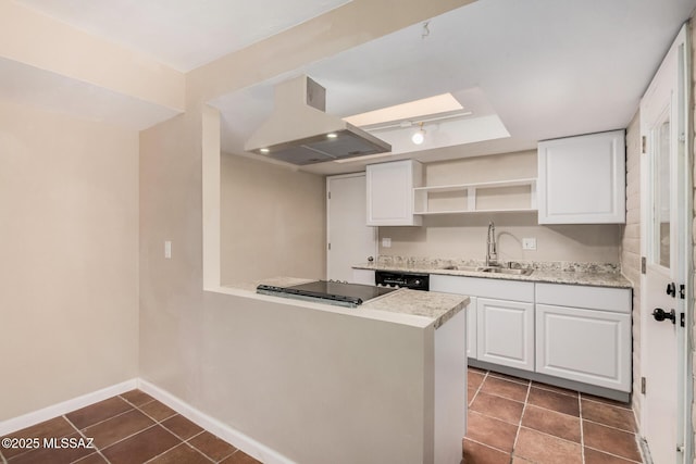 7208 E Toronto St, Tucson, AZ 85730 - kitchen with island exhaust hood, open shelves, white cabinetry, a peninsula, and dark tile patterned floors