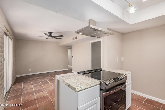 7208 E Toronto St, Tucson, AZ 85730 - kitchen featuring electric stove, wall chimney exhaust hood, tile patterned floors, a ceiling fan, and white cabinets
