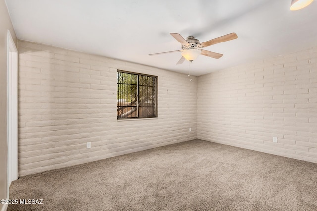 7208 E Toronto St, Tucson, AZ 85730 - carpeted spare room featuring a ceiling fan and brick wall