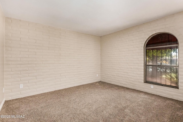 7208 E Toronto St, Tucson, AZ 85730 - carpeted empty room featuring brick wall