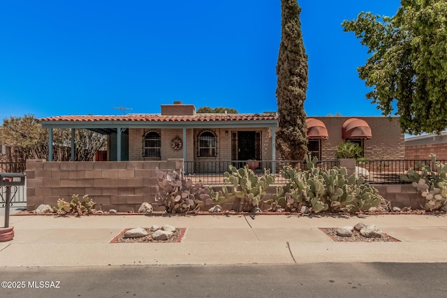 7208 E Toronto St, Tucson, AZ 85730 - view of front of property with a chimney, a tile roof, and brick siding