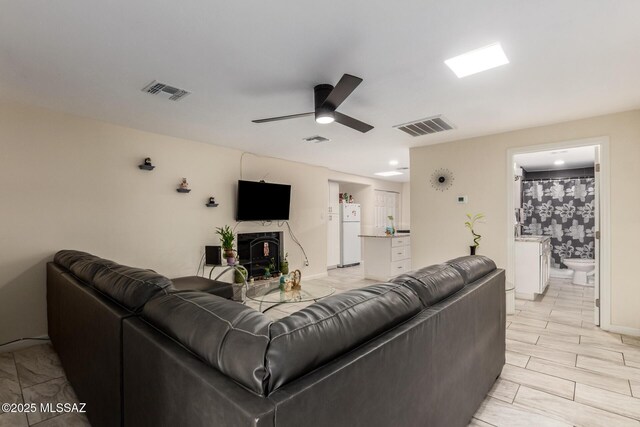 801 W Idaho St, Tucson, AZ 85706 - living area featuring a ceiling fan and a fireplace