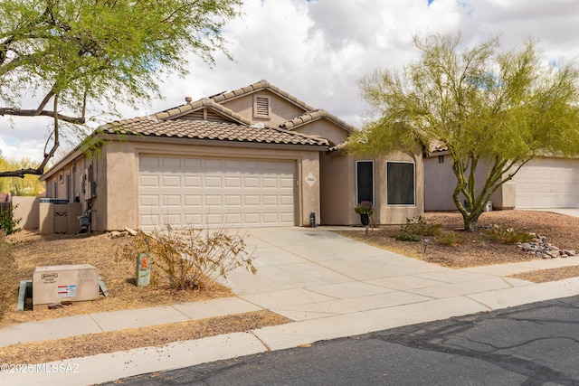 5566 W Dove Of Peace Dr, Marana, AZ 85658 - mediterranean / spanish home with an attached garage, stucco siding, concrete driveway, and a tiled roof