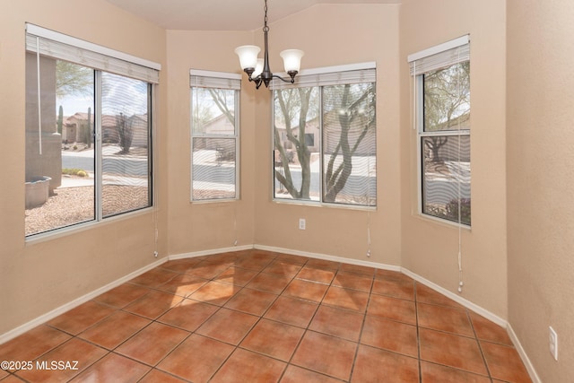 5566 W Dove Of Peace Dr, Marana, AZ 85658 - unfurnished dining area featuring tile patterned flooring, a chandelier, and vaulted ceiling