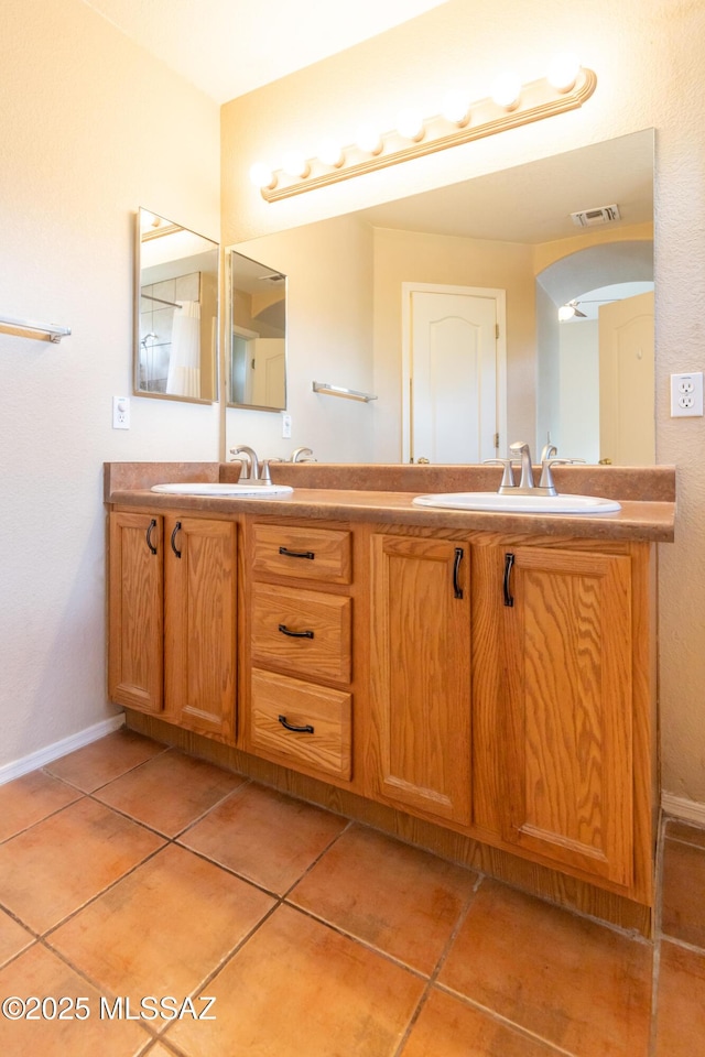 5566 W Dove Of Peace Dr, Marana, AZ 85658 - bathroom with double vanity and tile patterned floors