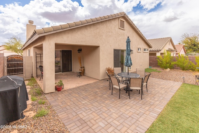 5566 W Dove Of Peace Dr, Marana, AZ 85658 - fenced backyard featuring a gate, grilling area, a patio, and outdoor dining area