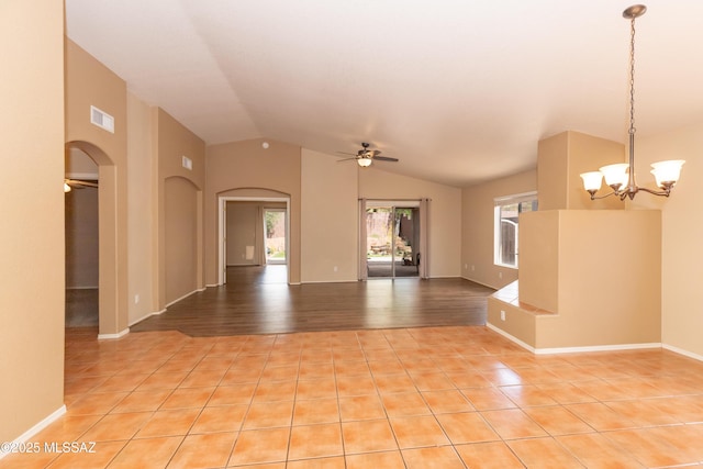 5566 W Dove Of Peace Dr, Marana, AZ 85658 - spare room with arched walkways, healthy amount of natural light, ceiling fan, vaulted ceiling, and a chandelier