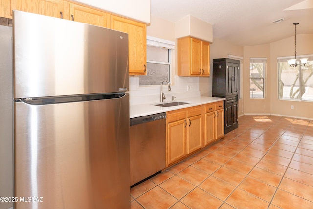 5566 W Dove Of Peace Dr, Marana, AZ 85658 - kitchen with stainless steel appliances, light countertops, tasteful backsplash, a chandelier, and light tile patterned floors