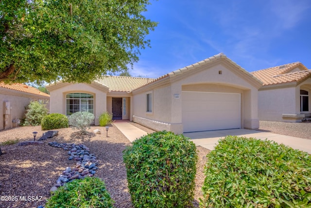 13491 N Tom Ryans Way, Oro Valley, AZ 85755 - view of front facade with stucco siding, a garage, a tiled roof, and driveway