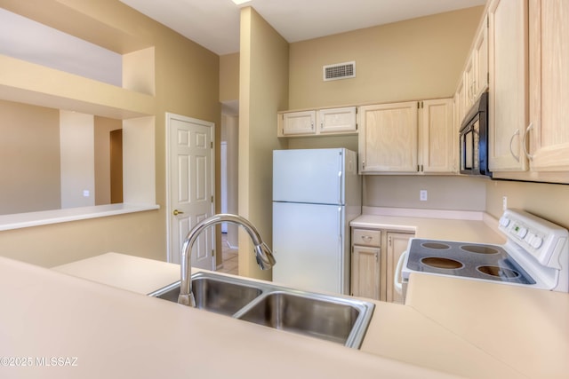 13491 N Tom Ryans Way, Oro Valley, AZ 85755 - kitchen with white appliances, light countertops, and light brown cabinets