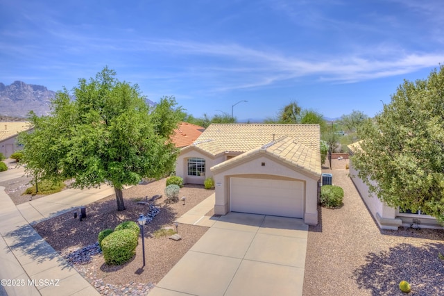 13491 N Tom Ryans Way, Oro Valley, AZ 85755 - mediterranean / spanish-style home featuring a tile roof, driveway, a garage, stucco siding, and a mountain view