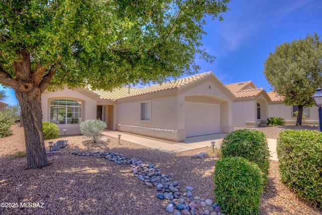 13491 N Tom Ryans Way, Oro Valley, AZ 85755 - view of front of home featuring a garage, stucco siding, and a tile roof