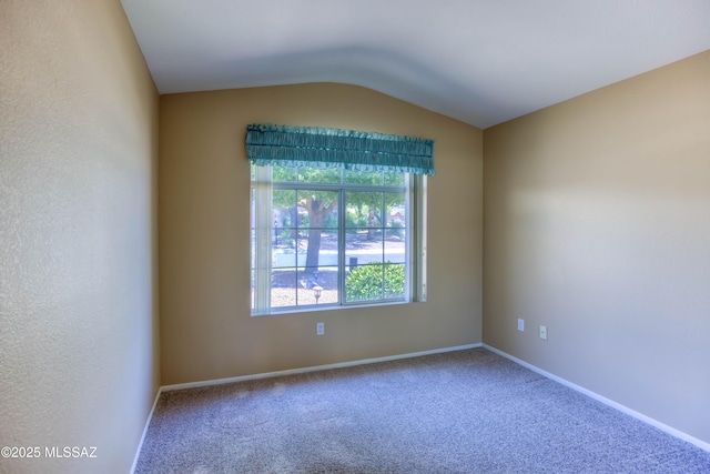 13491 N Tom Ryans Way, Oro Valley, AZ 85755 - spare room with carpet floors and vaulted ceiling