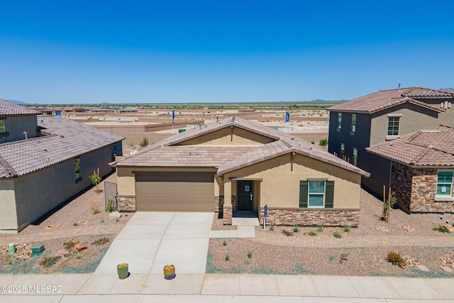 10490 W Beaman Ln, Marana, AZ 85653 - view of front of property featuring stucco siding, stone siding, driveway, and an attached garage