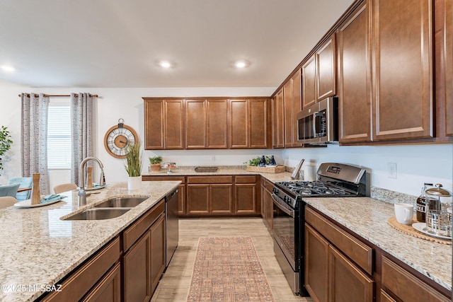 10490 W Beaman Ln, Marana, AZ 85653 - kitchen with stainless steel appliances, light wood-style floors, light stone countertops, and recessed lighting