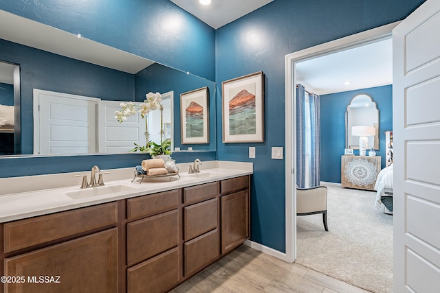 10490 W Beaman Ln, Marana, AZ 85653 - ensuite bathroom featuring double vanity and wood finished floors