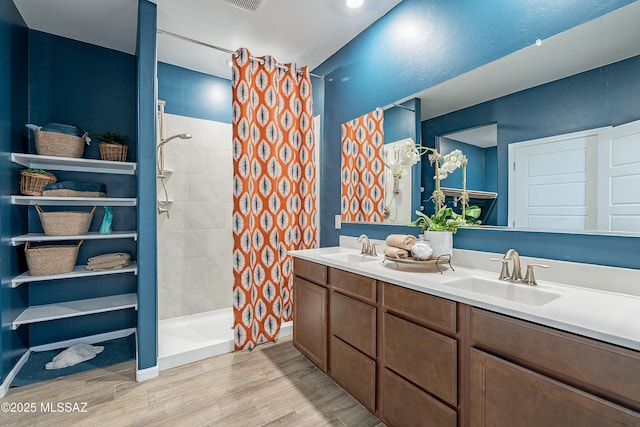 10490 W Beaman Ln, Marana, AZ 85653 - full bathroom with wood finished floors, a tile shower, and double vanity