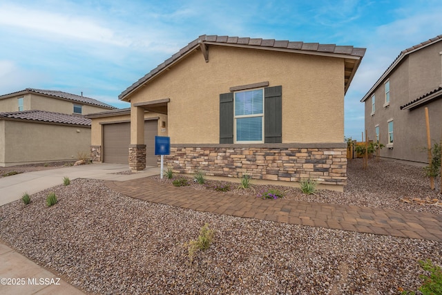 10490 W Beaman Ln, Marana, AZ 85653 - view of front of home with concrete driveway, stucco siding, a garage, and stone siding