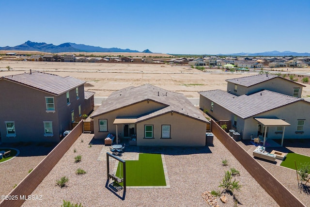 10490 W Beaman Ln, Marana, AZ 85653 - view of front of home featuring a mountain view, a fenced backyard, a patio area, and a residential view