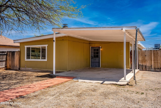 4812 E 3rd St, Tucson, AZ 85711 - rear view of house featuring a carport and a patio area
