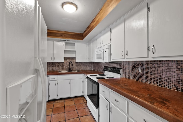 4812 E 3rd St, Tucson, AZ 85711 - kitchen featuring white appliances, dark countertops, tasteful backsplash, and white cabinetry