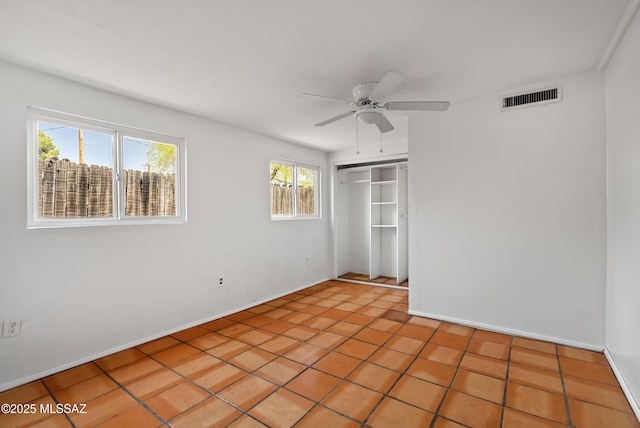 4812 E 3rd St, Tucson, AZ 85711 - unfurnished bedroom featuring a closet, a ceiling fan, and light tile patterned flooring