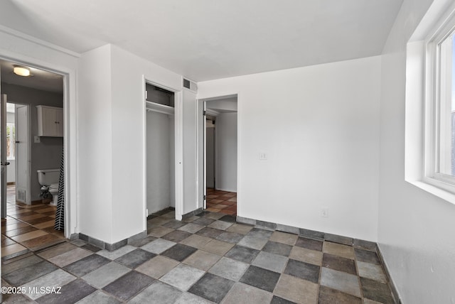 4812 E 3rd St, Tucson, AZ 85711 - unfurnished bedroom featuring a closet and stone finish flooring