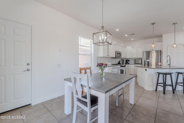 10567 E Desert Drifter Pl, Tucson, AZ 85747 - dining room featuring light tile patterned flooring, a chandelier, and recessed lighting