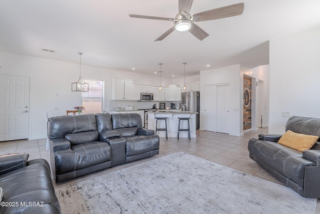 10567 E Desert Drifter Pl, Tucson, AZ 85747 - living area featuring light tile patterned floors, ceiling fan, a chandelier, and recessed lighting