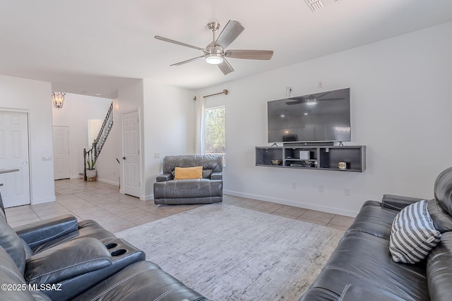 10567 E Desert Drifter Pl, Tucson, AZ 85747 - living room featuring light tile patterned flooring, ceiling fan, and stairs