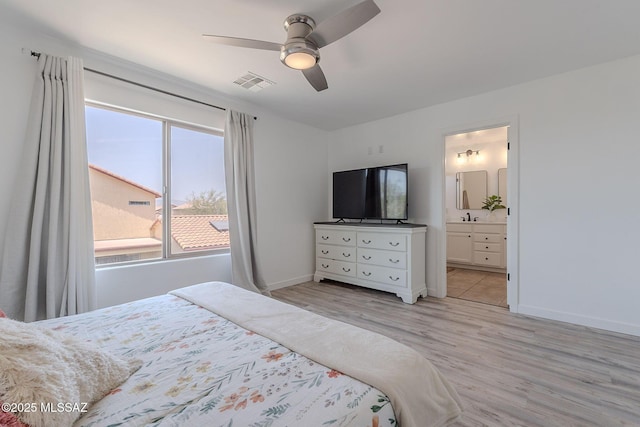 10567 E Desert Drifter Pl, Tucson, AZ 85747 - bedroom with multiple windows, light wood finished floors, ceiling fan, and connected bathroom