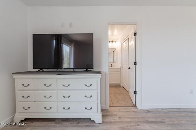 10567 E Desert Drifter Pl, Tucson, AZ 85747 - bedroom featuring light wood-type flooring and ensuite bath