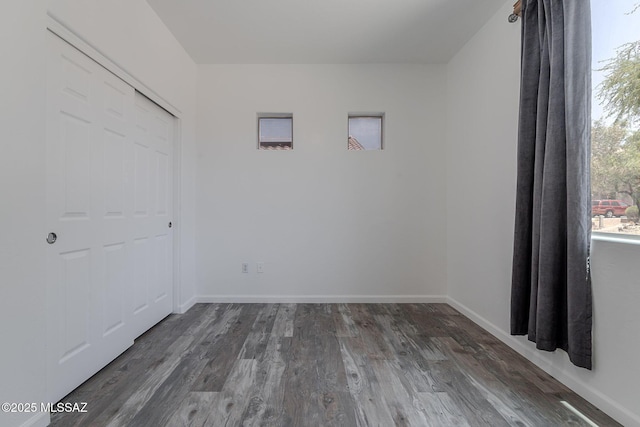 10567 E Desert Drifter Pl, Tucson, AZ 85747 - unfurnished bedroom with wood finished floors and a closet