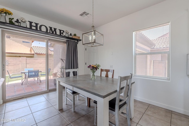 10567 E Desert Drifter Pl, Tucson, AZ 85747 - dining space featuring light tile patterned floors and a chandelier