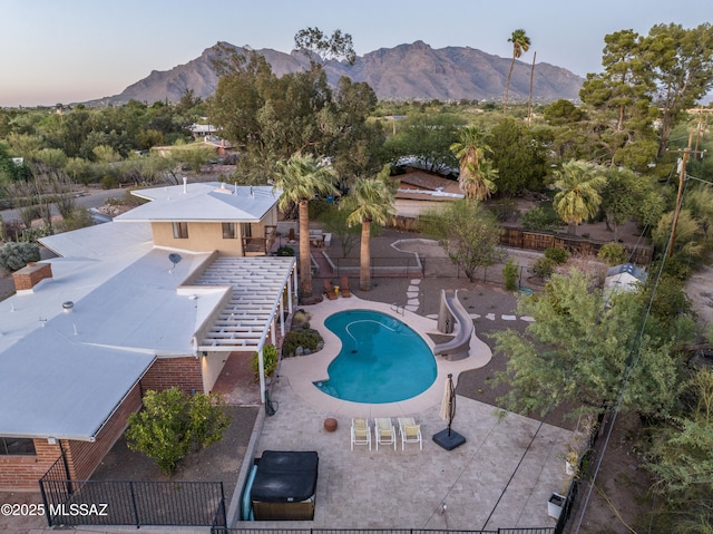 1115 W Santo Domingo Cir, Tucson, AZ 85704 - view of swimming pool with a mountain view, a water slide, a fenced backyard, and a patio area
