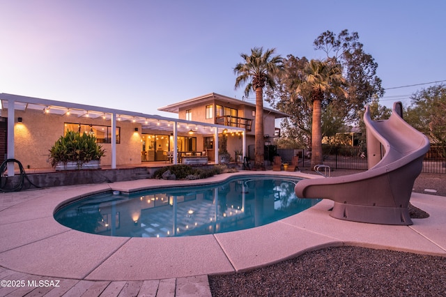 1115 W Santo Domingo Cir, Tucson, AZ 85704 - pool at dusk with a water slide and a patio area