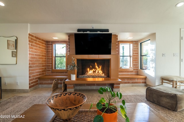 1115 W Santo Domingo Cir, Tucson, AZ 85704 - living room with a fireplace, recessed lighting, tile patterned flooring, and brick wall
