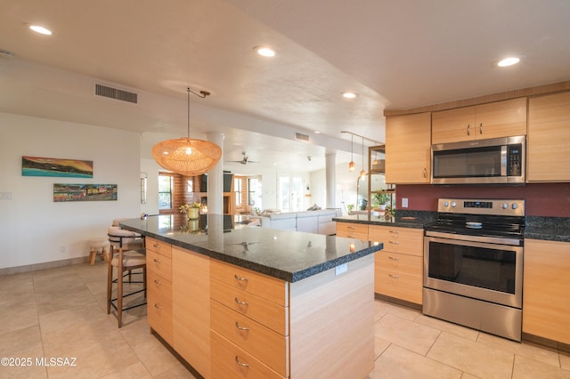 1115 W Santo Domingo Cir, Tucson, AZ 85704 - kitchen featuring appliances with stainless steel finishes, light brown cabinets, light tile patterned flooring, a kitchen island, and recessed lighting
