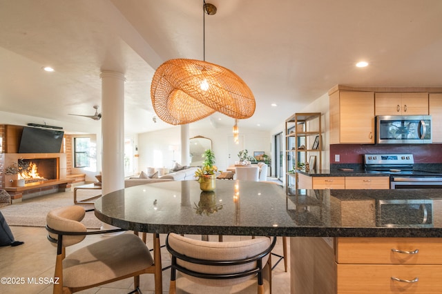 1115 W Santo Domingo Cir, Tucson, AZ 85704 - kitchen with stainless steel appliances, open floor plan, vaulted ceiling, decorative columns, and recessed lighting