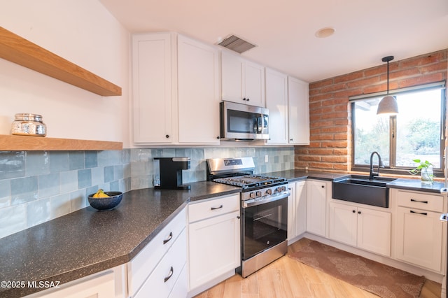 1115 W Santo Domingo Cir, Tucson, AZ 85704 - kitchen with stainless steel appliances, open shelves, dark countertops, and tasteful backsplash