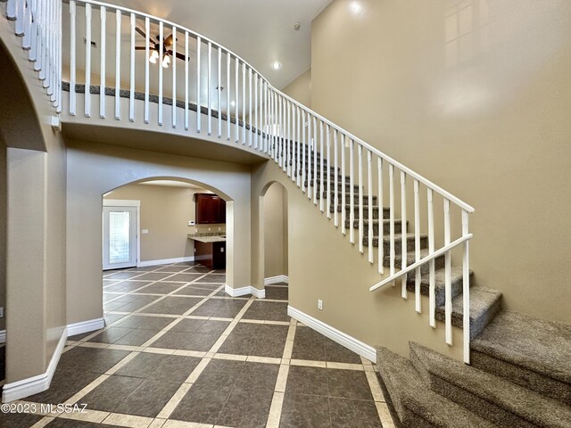 508 N Eagle Meadow Loop, Thatcher, AZ 85552 - stairway with inlaid floor details, arched walkways, a towering ceiling, and recessed lighting