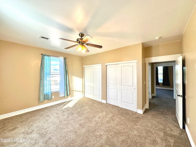 508 N Eagle Meadow Loop, Thatcher, AZ 85552 - unfurnished bedroom with multiple closets, carpet floors, and a ceiling fan