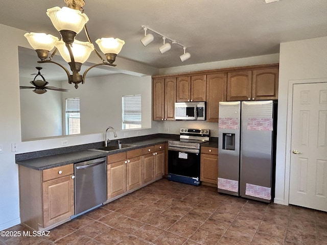 3365 N River Rapids Dr, Tucson, AZ 85712 - kitchen with stainless steel appliances, dark countertops, a ceiling fan, and a chandelier