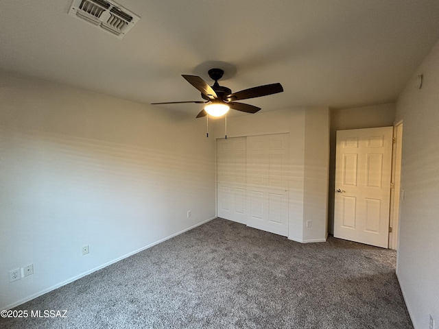 3365 N River Rapids Dr, Tucson, AZ 85712 - unfurnished bedroom with dark carpet, a closet, and ceiling fan