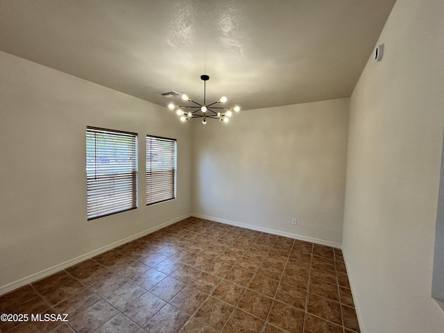 3365 N River Rapids Dr, Tucson, AZ 85712 - unfurnished room featuring a chandelier and baseboards