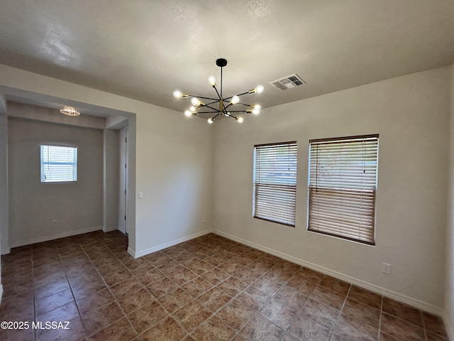 3365 N River Rapids Dr, Tucson, AZ 85712 - unfurnished room with a chandelier and baseboards