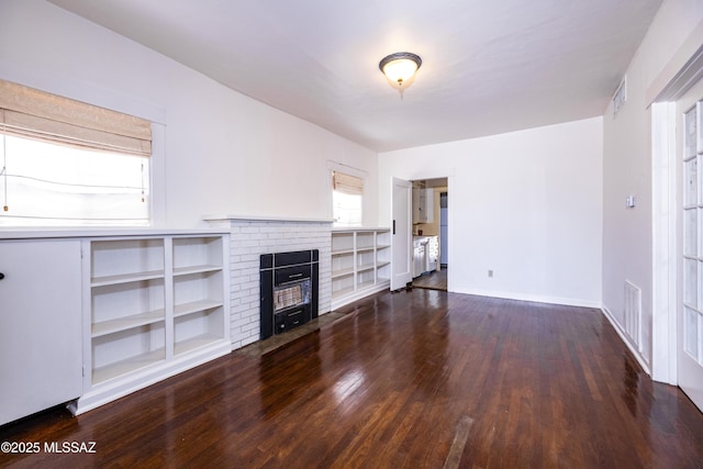 1809 E 8th St, Tucson, AZ 85719 - unfurnished living room with wood finished floors, a brick fireplace, and built in features