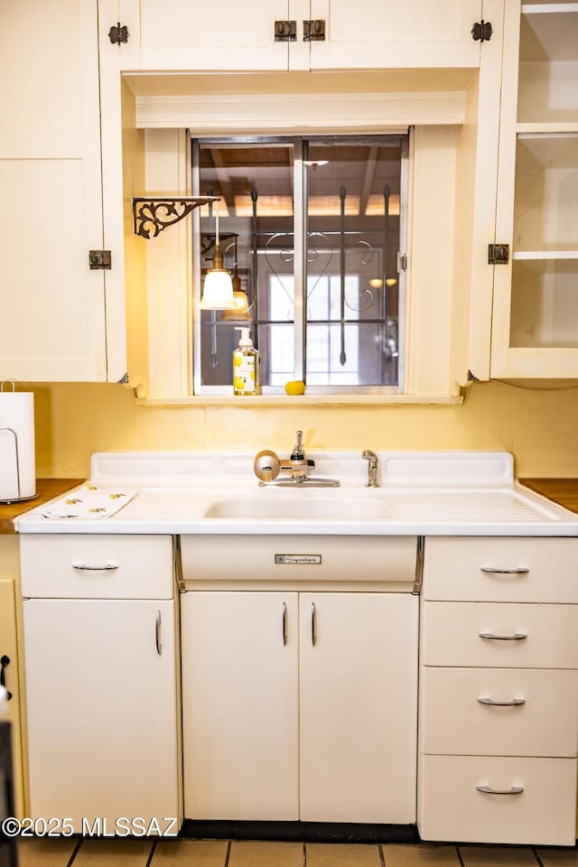 1809 E 8th St, Tucson, AZ 85719 - kitchen featuring white cabinetry and light countertops