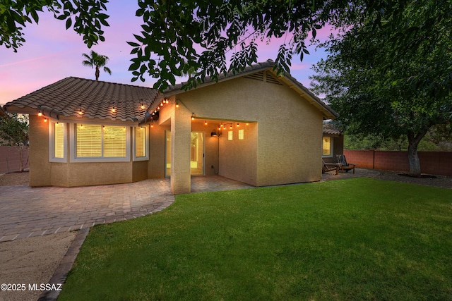 1026 E Madera Estates Ln, Sahuarita, AZ 85629 - rear view of property featuring stucco siding, a tiled roof, a fenced backyard, and a patio
